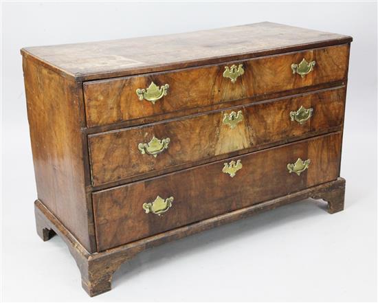 A George II and later walnut chest of three long drawers, W. 3ft 9.5in. D. 1ft 9in. H. 2ft 6in.